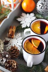 Mulled wine with spices and citrus fruit on vintage tray