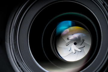 Close up shot of Camera Lens on the black background.
lens diaphragm macro with reflection



