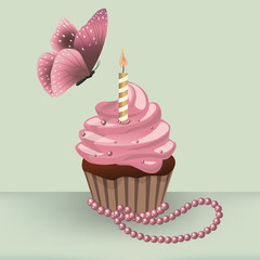 Birthday cupcake with burning candle and butterfly on the table with pearl necklace