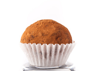 One chocolate candy on a light background