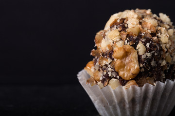 One chocolate candy on a slate background