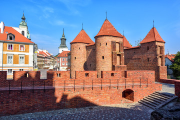 Fototapeta na wymiar Red brick walls and towers of Warsaw Barbican, Poland