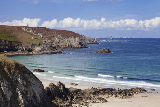View from Baie des Trepasses to the lighthouse at Pointe du Raz and the Isle de Sein, Peninsula Sizun, Finistere, Brittany, France 