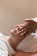 Face massage. Young woman getting spa treatment, close up, look