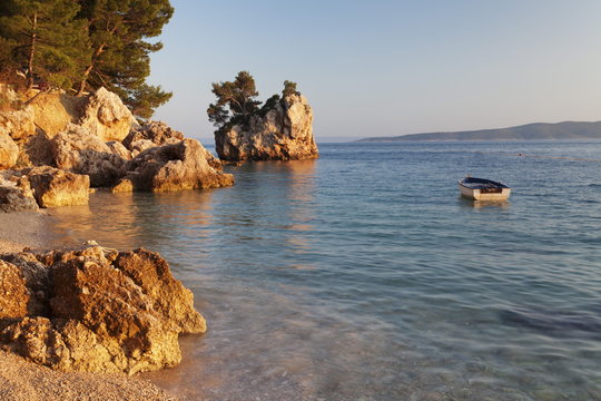 Coastal landscape with a rock and a rowing boat, Brela, Makarska Riviera, Dalmatia, Croatia 