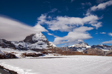 Obraz premium Matterhorn covered with clouds on a clear day after snow fall in autumn, Valais, Switzerland