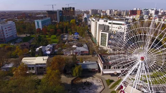 Aerial shot of the russian south city - Krasnodar. Panorama of the city. Ferris wheel. Big wheel. 4K