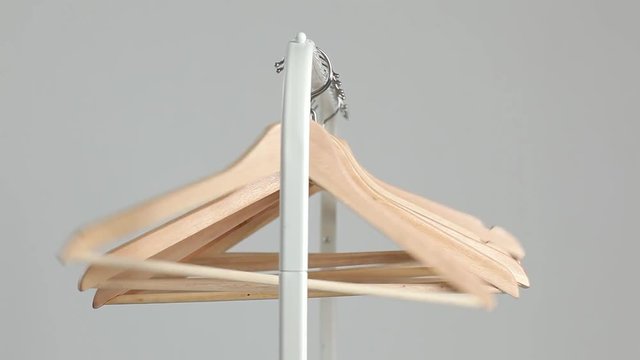 Number of empty hangers after a major sell-off in the store. Wooden bright hangers for coat and dress on the rack