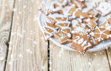 Some gingerbread on plate on a wood background.
