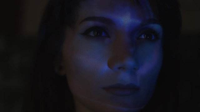 4k Abstract Shot of a Woman Face with Projector Reflection of Shooting Stars