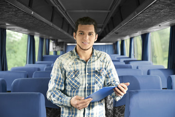 Conductor inside bus with clipboard