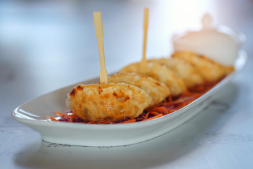 Dumplings fried in white dish.