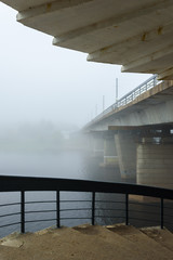 misty morning in Pskov , the river and bridge, shrouded in fog