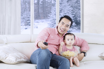 Fototapeta premium Happy father holds remote control