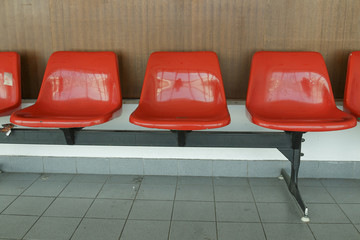 Fototapeta na wymiar Row red chair on the wall