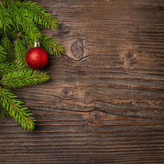 Obraz na płótnie Canvas Christmas tree and red ball on wooden background