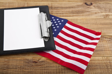 blank clip board and USA flag