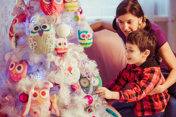 Fototapeta na wymiar mother and son decorating Christmas tree