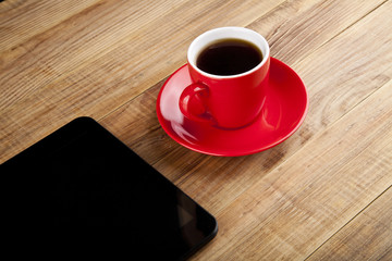 black tablet PC and coffee Cup