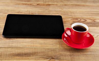 black tablet PC and coffee Cup