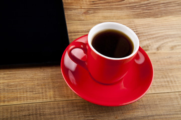 black tablet PC and coffee Cup