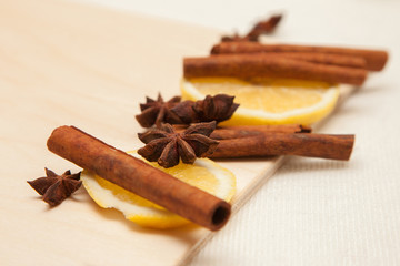 spice cinnamon (Cinnamomum), anise (Anisium vulgare Gaerto) and a cup of tea on a light wooden cutting board, closeup, background, healthy lifestyle