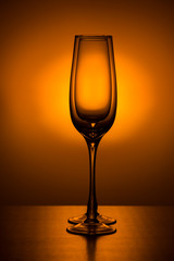 Two empty champagne glass on Orange spot background