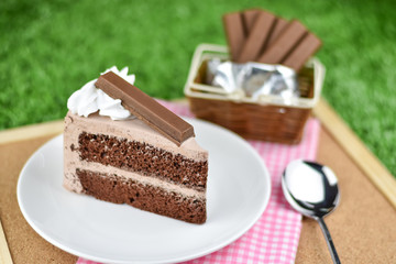 chocolate cake with whip cream and chocolate wafer topping