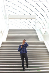 cool young black guy on stairs talking on cell phone