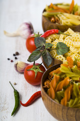 Pasta and ingredients: chili, tomatoes, basil, garlic and parsle