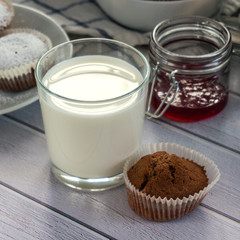 glass of milk, cupcake and red jam. Instagram square