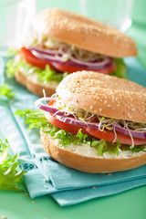 tomato sandwich on bagel with cream cheese onion lettuce alfalfa