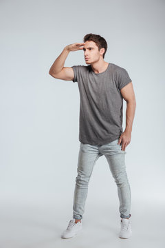 Full length portrait of a man straring far away