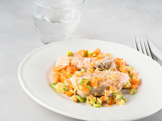 Steamed salmon with carrots, courgette and sesame seeds