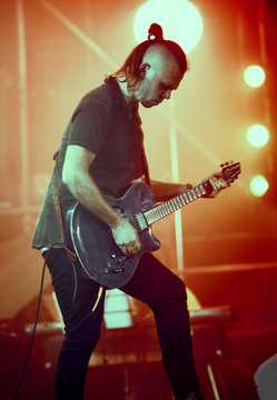 Guitarist performing on stage.