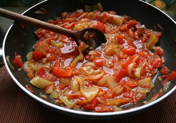 Peppers and tomato in a pan close up 