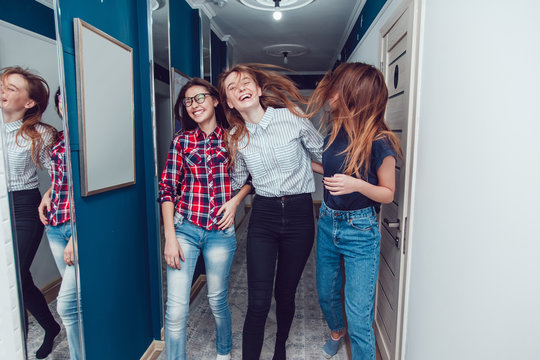 Pretty girls walk down the hall in hostel and fun.