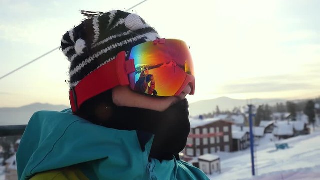Skier in glasses skiing downhill in high mountains on ski lift during sunny day in slow motion. 1920x1080