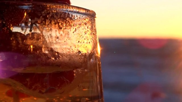 glass candle and sunset