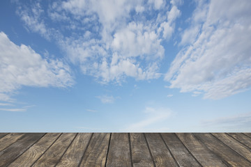 Naklejka na ściany i meble Wooden table on Blue sky background.