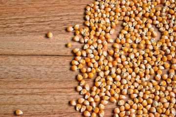 Popcorn kernels on a wooden table