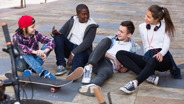 Group of  teenage friends relaxing and chatting