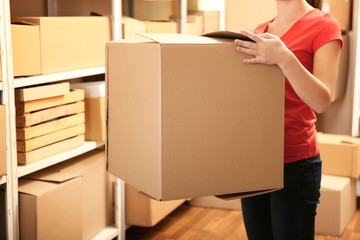 Woman holding box at warehouse