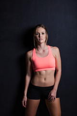 Fototapeta na wymiar Beautiful female fitness model holding a towel/weights