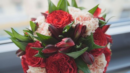 Colorful - red and green - wedding flowers - bride's bouquet at window, close up