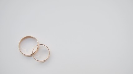 Golden wedding rings on white background