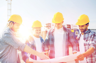 group of builders with tablet pc and blueprint