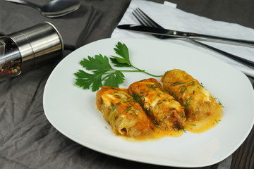 Stuffed cabbage rolls with rice and meat in tomato sauce