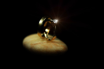 Jewellery diamond ring on a black background with lighting over