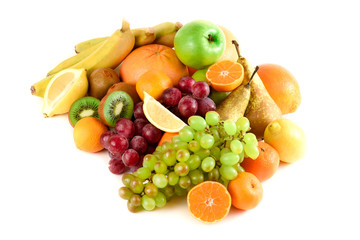 Many colorful, bright, fresh fruit on a white background. Kiwi, grapefruits, bananas, grapes, lemon, mandarins, oranges, pear.